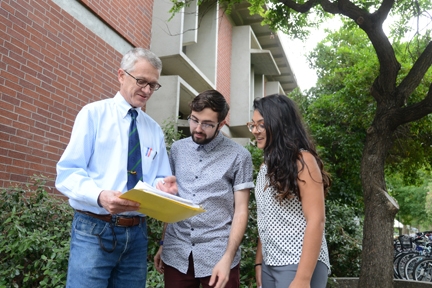 Professor Walter Leal goes over plans for the Zika Public Awareness Symposium with two of his students, Hanni Newland (center) and Nepheli Aji. (Photo by Kathy Keatley Garvey)