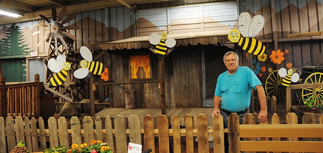 Dave Hutson, superintendent of the Dixon May Fair's Floriculture Building, stands in front of a bee-decorated exhibit. (Photo by Kathy Keatley Garvey)