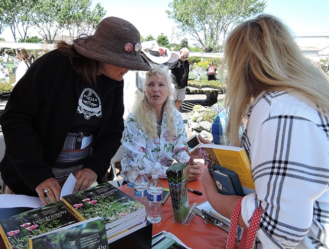 Following her talk at Annie's Annuals and Perennials, Richmond, Kate Frey (center) answers questions and signs copies of her book,