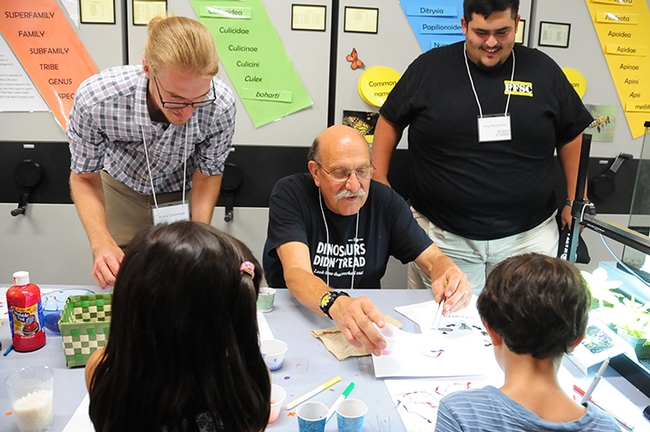 Forensic entomologists and NAFEA members (from left) Royce Cumming of Salinas Valley, Bob Kimsey of UC Davis and Greg Nigoghosian of Purdue engage in a maggot art activity. (Photo by Kathy Keatley Garvey)