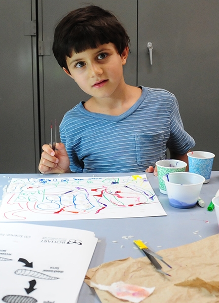 Neel Fulde, 7, of Davis, is eager to work on his maggot art painting. (Photo by Kathy Keatley Garvey)