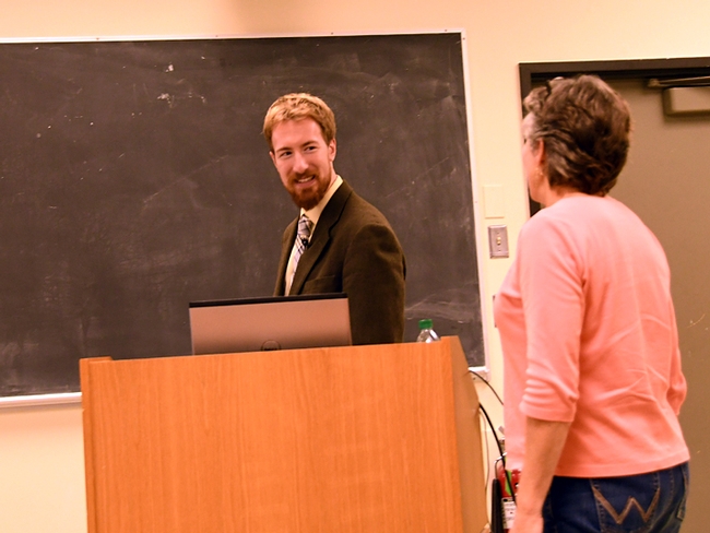 Matan Shelomi heads to the podium to deliver his seminar on his stick insect research. At right is major professor Lynn Kimsey, director of the Bohart Museum of Entomology. (Photo by Kathy Keatley Garvey)