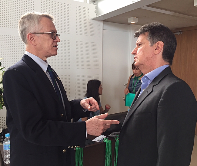 UC Davis chemical ecologist Walter Leal (left) talks with FUNDECITRUS director Juliano Ayres on Dec. 5 at the 10th Annual Meeting of Chemical Ecology in Sao Paulo.