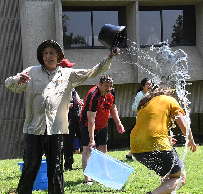 Proving himself an elite water warrior, Bruce Hammock nonchalantly empties a bucket of water on his doctoral student, Cindy McReynolds. 
