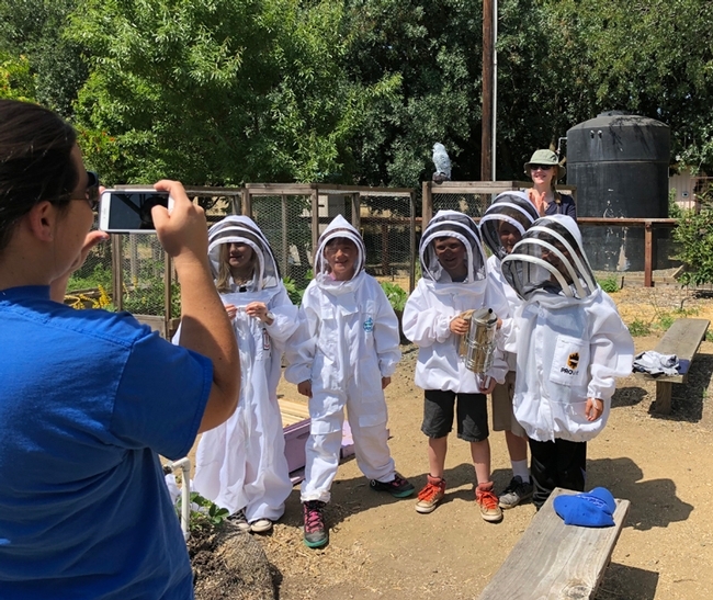 The youngsters enjoy dressing up in beekeeper protective suits and being photographed. (Photo by Kathy Keatley Garvey)
