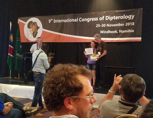 Professor Thomas Pape of the Natural History Museum of Denmark and chair of the Council for the International Congresses of Dipterology, presents the top student prize to Jessica Gillung. The next Congress takes place in 2022 in California