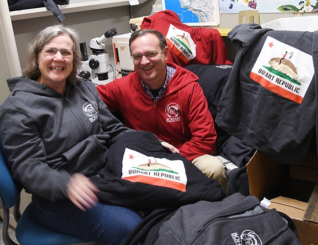 The Professors: Fran Keller, assistant professor at Folsom Lake College, and Jason Bond, Evert and Marion Schlinger Endowed Chair in Insect Systematics in the UC Davis Department of Entomology and Nematology, are surrounded by hooded sweatshirts available for sale at the Bohart Museum. Keller, who holds a doctorate in entomology from UC Davis, designed the hoodies. Bond, a spider expert, will be presenting displays at the Bohart Museum's open house on March 9. (Photo by Kathy Keatley Garvey)