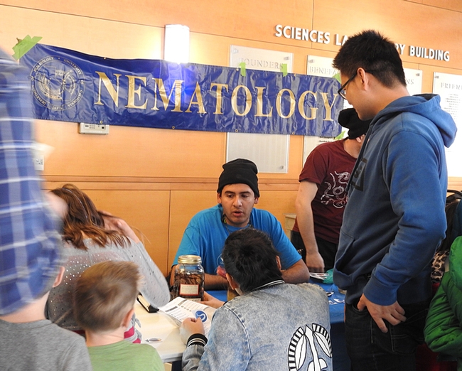 Entomologist Diego Rivera, an undergraduate student at UC Davis, chats with the crowd in the Sciences Laboratory Building. (Photo by Kathy Keatley Garvey)