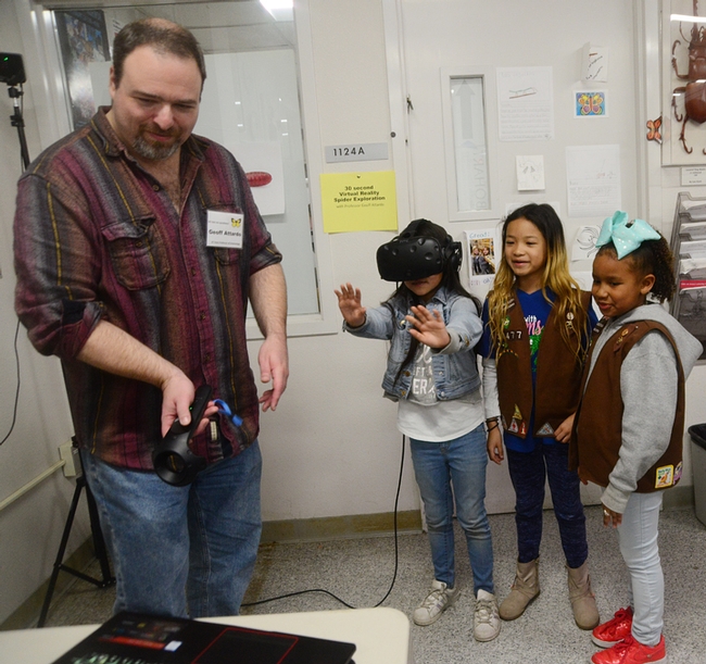 At a recent Bohart Museum of Entomology open house on spiders, medical entomologist Geoffrey Attardo demonstrated his virtual reality system. The girls, members of Brownie Girl Scout Troop 30477, Vacaville, are (from left) Jayda Navarrette, 8; Keira Yu, 8, and Kendl Macklin, 7. (Photo by Kathy Keatley Garvey)