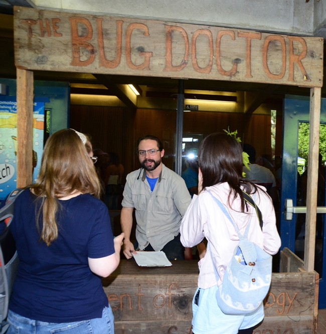 Doctoral candidate Brendon Boudinot answers questions about insects in the Bug Doctor booth at Briggs Hall. (Photo by Kathy Keatley Garvey)
