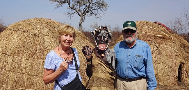 James R. Carey, UC Davis distinguished professor of entomology and his wife, Patty, with a Mursi woman (Ethiopia)  showing her lip plate. Also known as a lip disc, it is a status symbol among the Mursi women.