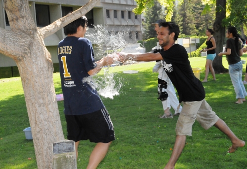 Jun Yang (left), a postdoctoral fellow in the Bruce Hammock lab and an analytical chemist, gets drenched by entomologist Junaid ur Rehman, who is visiting the Bruce Hammock lab from Quaid-e-Azam University, Islamabad, Pakistan. (Photo by Kathy Keatley Garvey)