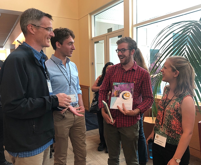 Discussing the conference are these members of the Neal Williams lab. From left pollination ecologist Neal Williams, professor, UC Davis Department of Entomology and Nematology, and Nick Rosenberger, Colin Fagan and Anna Britzman. (Photo by Kathy Keatley Garvey)