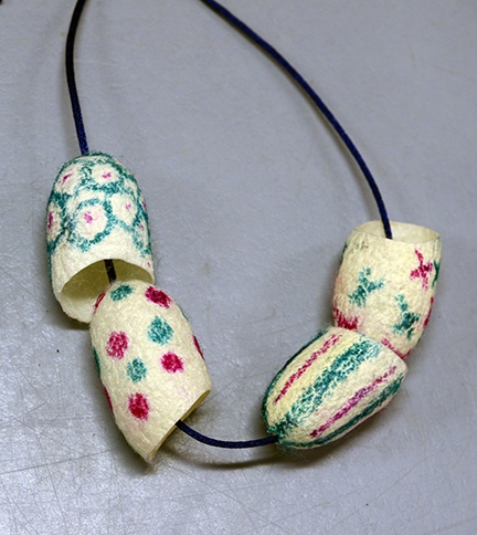 A cocoon necklace. (Photo by Kathy Keatley Garvey)