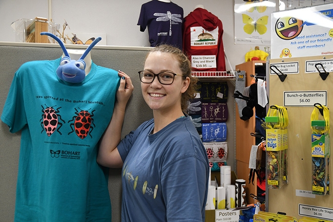 Insect-themed t-shirts are popular in the Bohart Museum of Entomology gift shop, especially during the holiday season. This is entomologist Eliza Litsey. (Photo by Kathy Keatley Garvey)