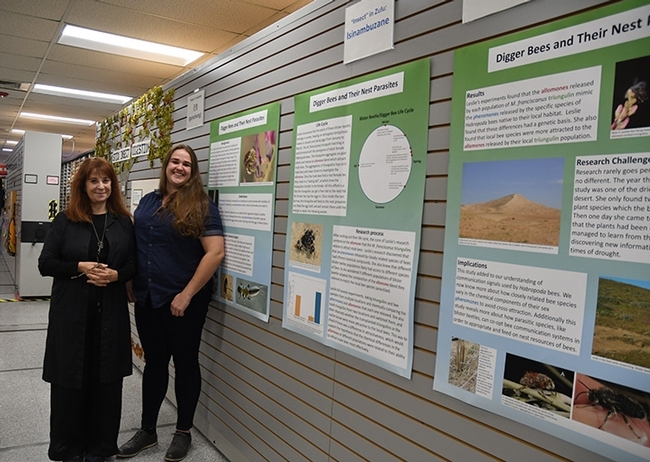 Leslie Saul-Gershenz (left) and curator Emma Cluff stand by their display at the Bohart Museum of Entomology. (Photo by Kathy Keatley Garvey)