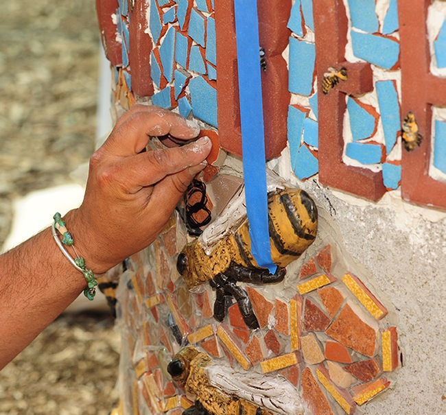 The hands of Mark Rivera as he works to install art projects at the Häagen-Dazs Honey Bee Haven at UC Davis. (Photo by Kathy Keatley Garvey)