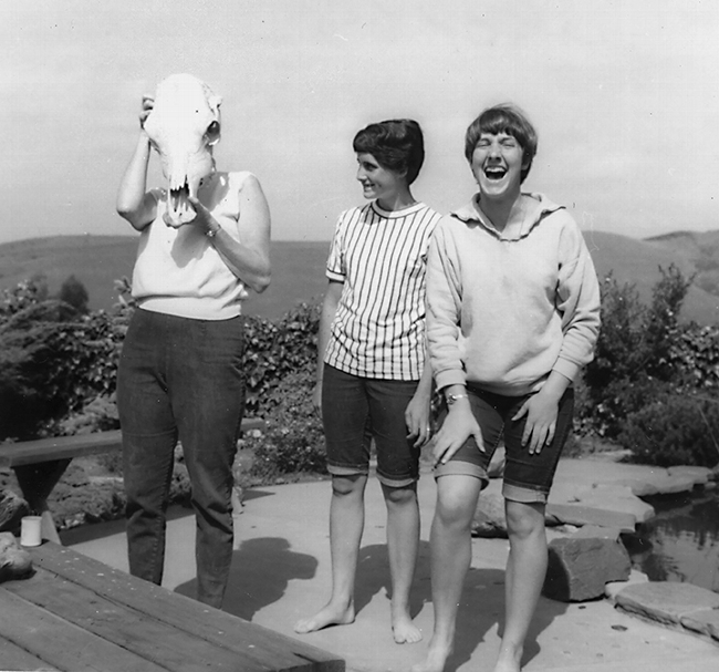 Lynn Siri (far right), now  UC Davis professor Lynn Kimsey, laughs with her sister, Anne, as their mother, Jean Siri, tries on a skull.