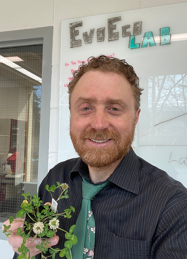 Evolutionary biologist Marc Johnson of the University of Toronto, shown here with a bouquet of white clover, has a double reason to celebrate. The white clover research he led was published on St. Patrick's Day, which is also his birthday anniversary.