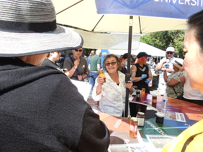 Amina Harris, director of the UC Davis Honey and Pollination Center, explained her honey flavor wheel and offered honey samples. She is a co-founder of the California Honey Festival. (Photo by Kathy Keatley Garvey)