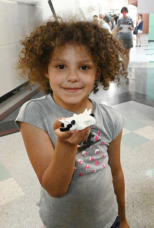 Alexis Rainwater, 8, of Woodland, shows the spider she hand-crafted. (Photo by Kathy Keatley Garvey)