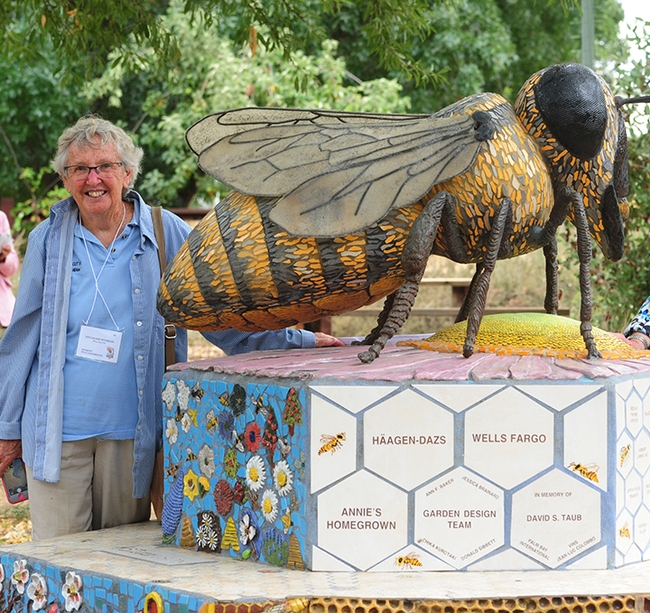 Ettamarie Peterson, known as the Sonoma County Queen Bee, stands by the bee sculpture, Miss Bee Haven, that anchors the UC Davis Bee Haven. (2007 Photo by Kathy Keatley Garvey)