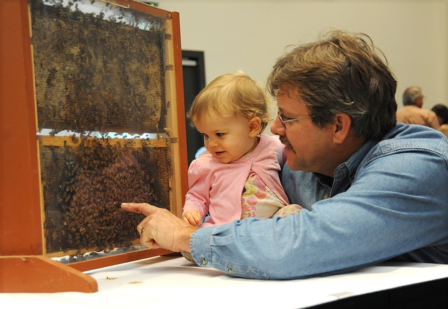 Future beekeeper Emily Fishback with her beekeeper-father Brian Fishback of Wilton, who provided the bee observation hives. (Photo by Kathy Keatley Garvey)