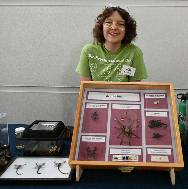 UC Davis entomology freshman student Kat Taylor answers questions at the Jason Bond lab display table. (Photo by Kathy Keatley Garvey)