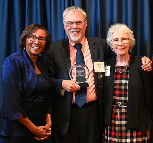 Honey bee geneticist Robert E. Page Jr. poses with his wife Michelle (right) and Helene Dillard, dean of the UC Davis College of Agricultural and Environmental Sciences at a 2022 ceremony honoring him as the recipient of the CA&ES Distinguished Emeritus Award. (Photo by Kathy Keatley Garvey)