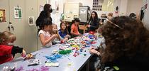 With UC Davis students (right) assisting at the Bohart Museum arts-and-crafts table, artists create arthropods and other critters, using modeling clay. (Photo by Kathy Keatley Garvey) for Bug Squad Blog