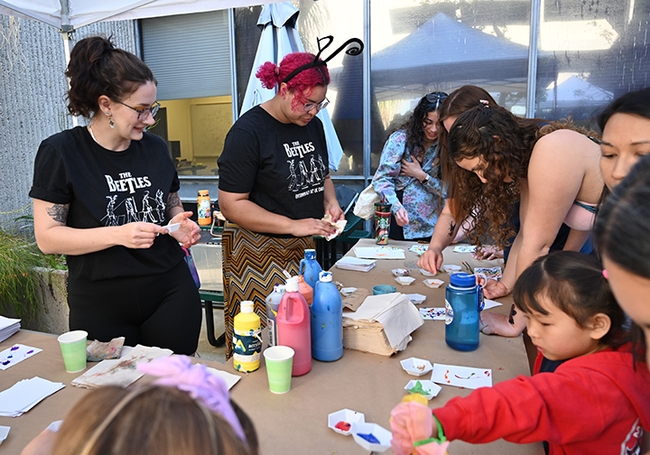 UC Davis entomologists, first-year doctoral students Abigail Lehner (front) of the Neal Williams lab, and Iris Quayle of the Jason Bond lab, staff the Maggot Art table at Briggs Hall. (Photo by Kathy Keatley Garvey)