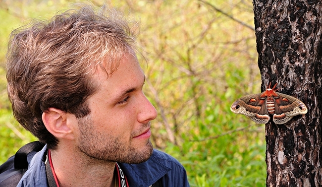 Sam Jaffe, founder and executive director of The Caterpillar Lab, looking at a 