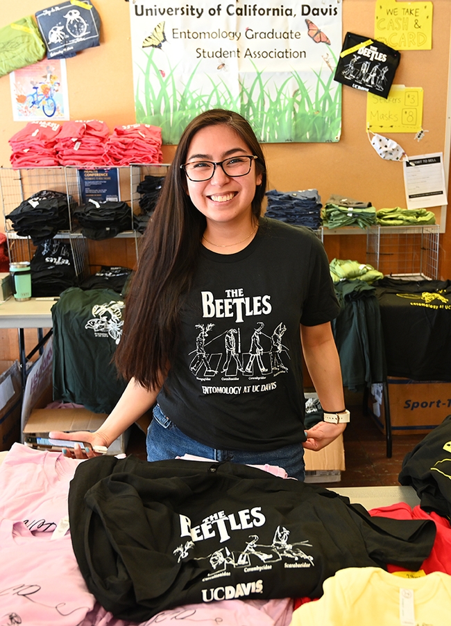 Doctoral candidate Christine Tabuloc of the Joanna Chiu lab and a member of the UC Davis Entomology Graduate Student Association (EGSA), Department of Entomology and Nematology, kept busy selling EGSA t-shirts. The most popular? The Beetles. (Photo by Kathy Keatley Garvey)