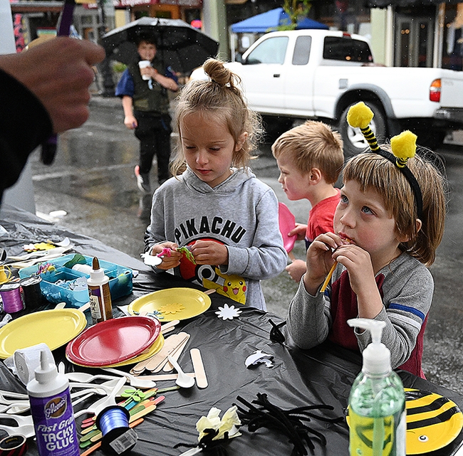 Thomas Bigham, 4, (foreground) of Woodland is excited about creating arts and crafts at the California Master Beekeeper Program booth. With him are his twin brother, Max, and sister, Sophia, 7. (Photo by Kathy Keatley Garvey)
