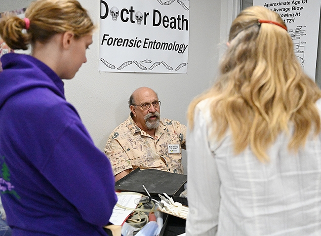 Forensic entomologist Bob Kimsey answering questions at his booth in the Bohart Museum of Entomology. (Photo by Kathy Keatley Garvey)
