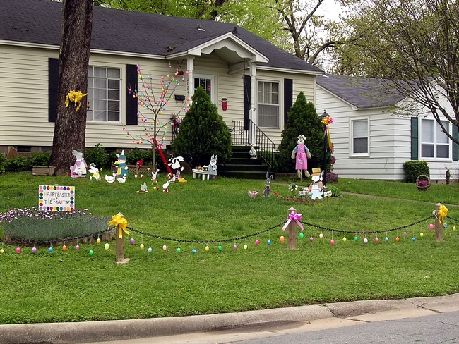 A fun, Easter decorated landscape with a lawn in front of a house.