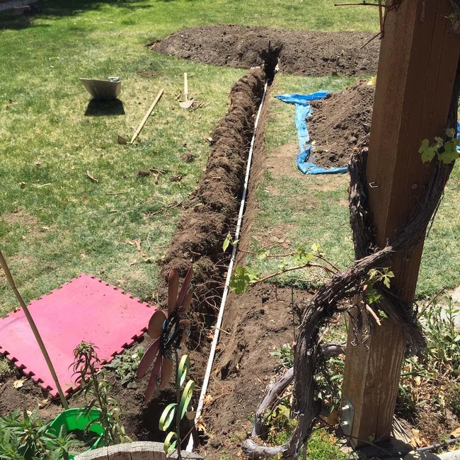 4/14/15: Trench dug and drip supply pipe installed and ready to backfill. Note the grass laid over to the left, making it easier to put it back where it came from.