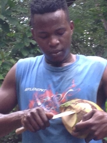 Boy opening coconut