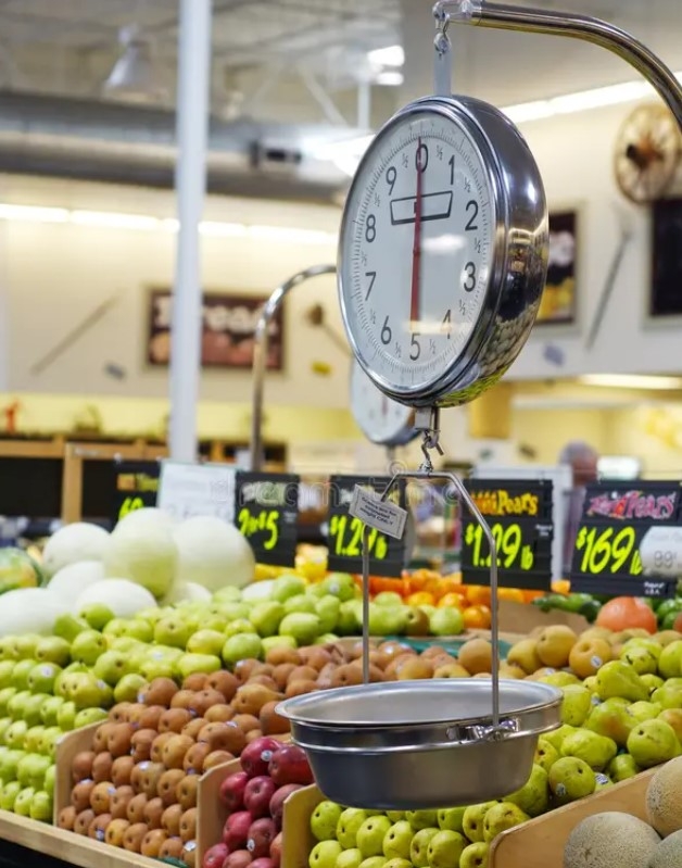 The image shows produce on a scale in a grocery store.