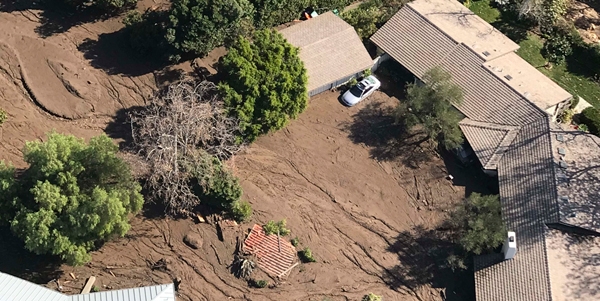 Santa Barbara County firefighter V. Agapito searches through a home Saturday that was destroyed by a deadly mudflow following heavy rainfall. Photo courtesy of Mike Eliason/Santa Barbara County Fire.