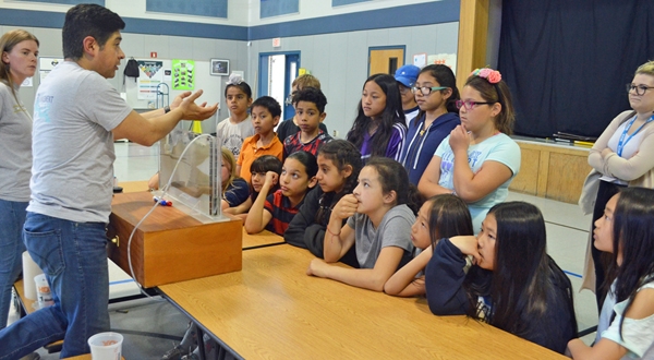 Dr. Sam Sandoval shows afterschool program youth a groundwater model. Photo by Marianne Bird.