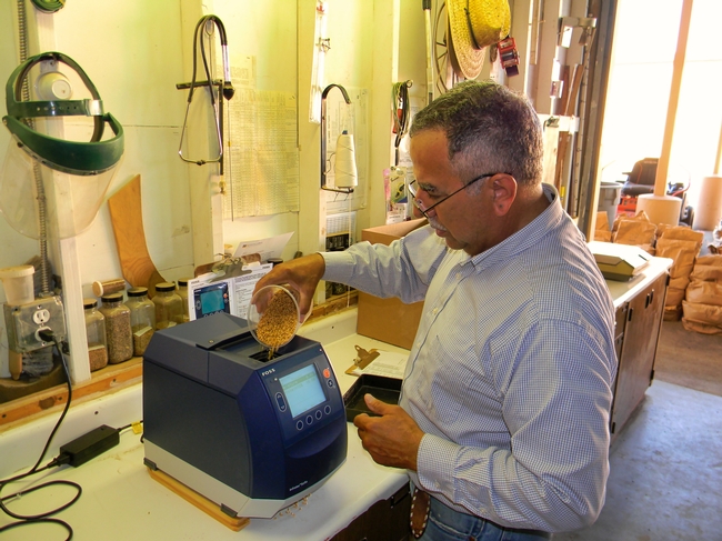 former staff research associate, Fracisco Maciel, determining the protein quantity of a wheat sample.