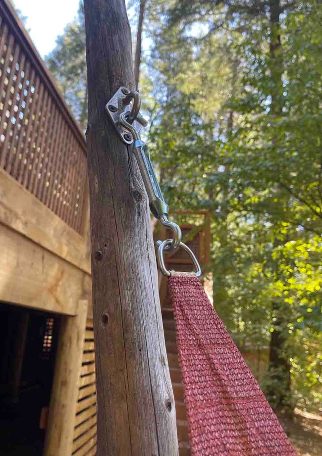 Close-up of pole mechanism holding decorative shade cloth. A turnbuckle is used to pull the shade cloth taut. Alton Wright