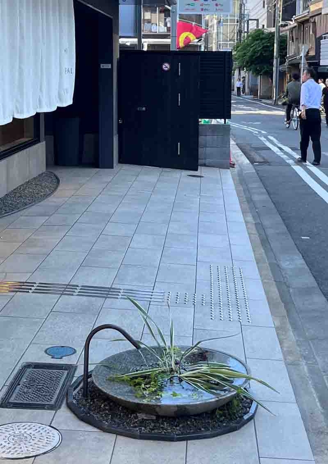 A small modern fountain creates interest along the side of a street in Kyoto. J.C. Lawrence