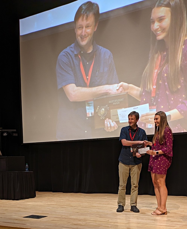 Doctoral candidate Alison Coomer Blundell receiving her first-place award ($250 and a plaque) in the three-minute student competition. She delivered a presentation on “Trade Offs Between Resistance Breaking and Fitness Cost in Root-Knot Nematodes.”
