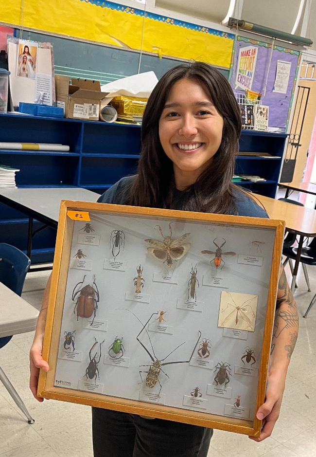 Mia Lippey, STEM Squad activity leader, with Bohart Museum of Entomology specimens.