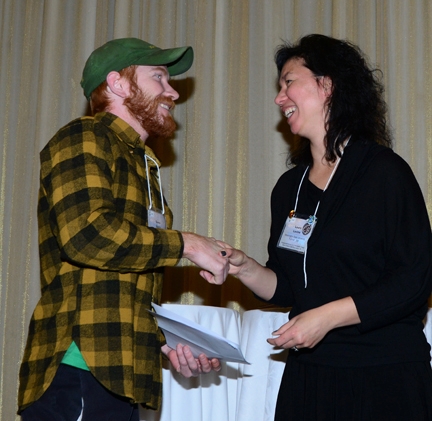 Daren Harris receives his poster award from PBESA's Laura Levine of WSU.