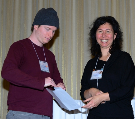 Scott McCluen receives his poster award from PBESA's Laura Levine of Washington State University.