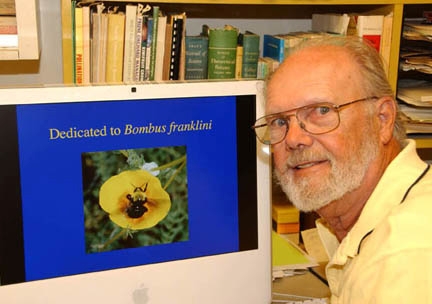 Bumble bee expert Robbin Thorp with a photo he took of Franklin's bumble bee. (Photo by Kathy Keatley Garvey)
