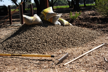 Mound of dirt and rake: indications of fence to be built. (Photo by Kathy Keatley Garvey)